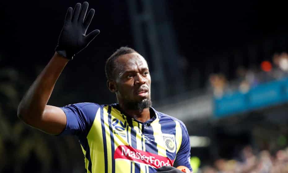 Usain Bolt waves to fans after playing for Central Coast Mariners