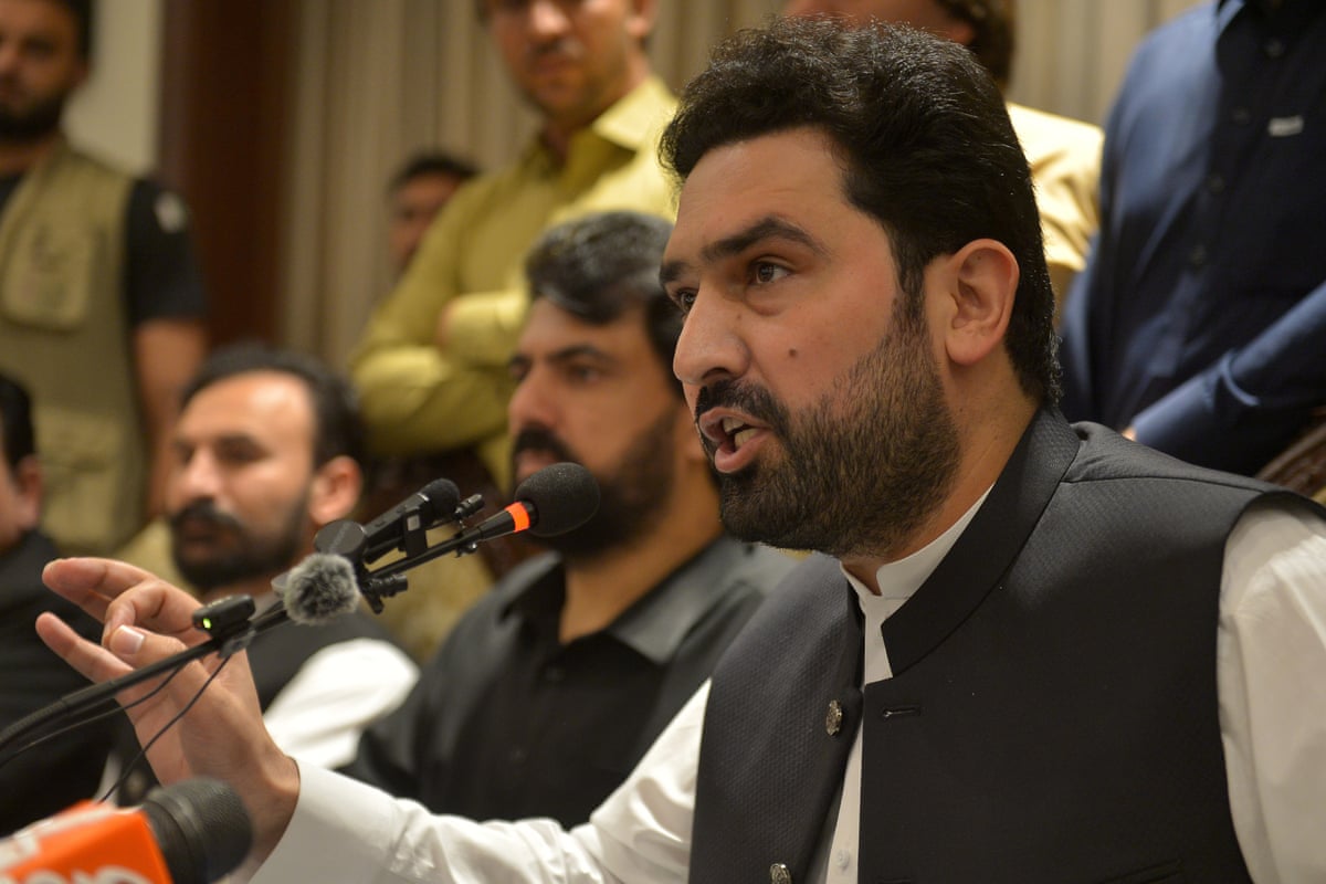 A man speaking into a microphone at a press event