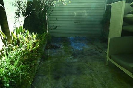 Exhibit from the trial of Beau Lamarre-Condon showing Luke Baird’s back courtyard during luminol analysis. The chemical highlights possible bloodstaining.
