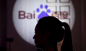 A woman is silhouetted against the Baidu logo at a new product launch from Baidu, in Shanghai, China, November 26, 2015. Thousands of apps running code built by Chinese Internet giant Baidu have collected and transmitted users' personal information to the company, much of it easily intercepted, researchers say. Picture taken November 26. REUTERS/Aly Song