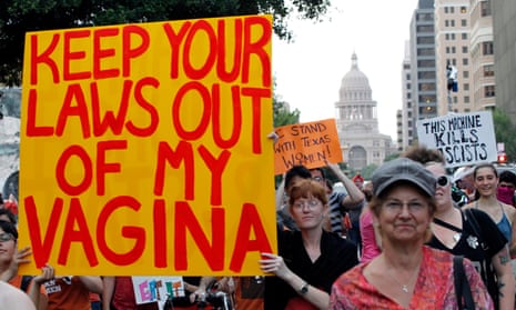 Abortion rights activist Elle Minter carries a sign during an abortion rights march in Austin, Texas.