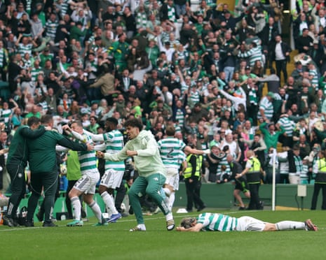 The Celtic players and fans erupt after Daizen Maeda’s late goal set them up to win the title.
