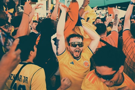 people with their arms up cheering
