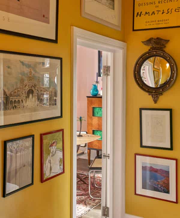 Bright yellow walls in the hall of the London home of interior designers and artists Luke Edward Hall and Duncan Campbell