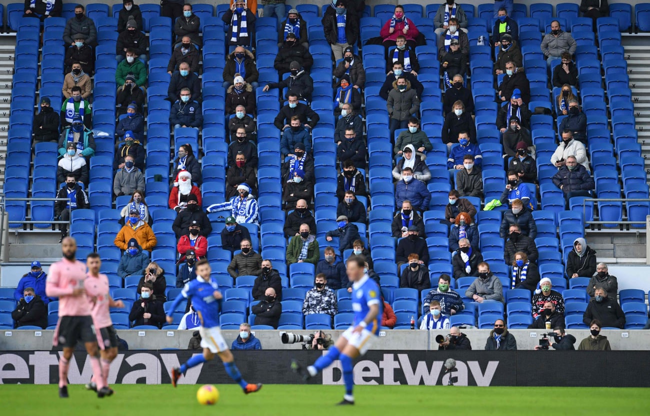 Supporters wearing face-masks while social-distancing at the Amex in Brighton.