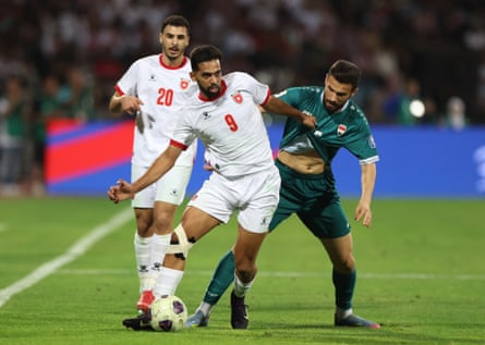 Jordan’s Ali Olwan shields the ball from Iraq’s Ali Faez in Amman.