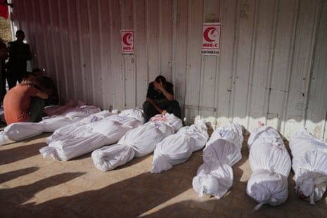 Palestinians mourn people killed in Israeli airstrikes in Jabalia, northern Gaza Strip, on Wednesday, 14 May.