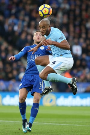 Vincent Kompany jumps to clear the ball away from Jamie Vardy