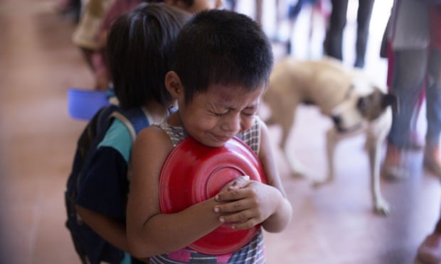 A child wait for a plate of food at a soup kitchen in Salta province, Argentina.