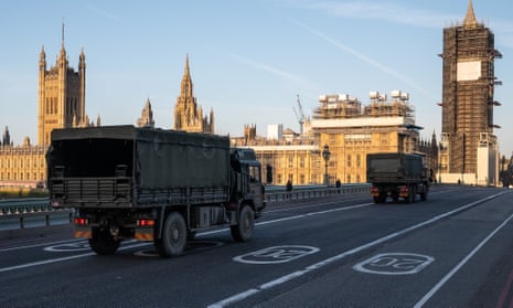 Military vehicles deliver masks to St Thomas’ hospital in London on 24 March 2020, the day after national lockdown began. 