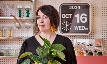 Green fingers: Cissi Åhlén with one of the many houseplants that bring even more life to the lively spaces.