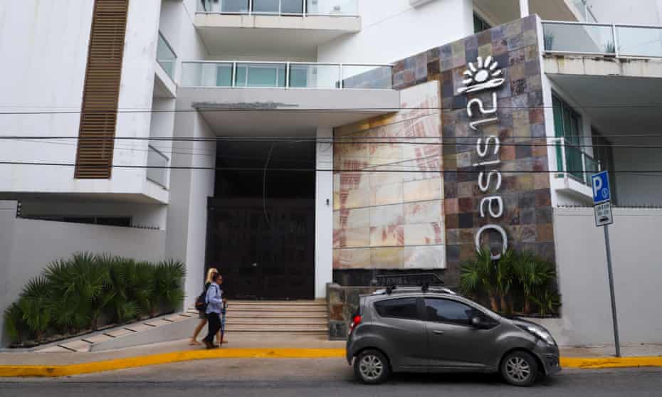People walk past Oasis 12 condo where two Canadian citizens were killed by unknown assailants, authorities said on Tuesday, in Playa del Carmen, Mexico, June 21, 2022.