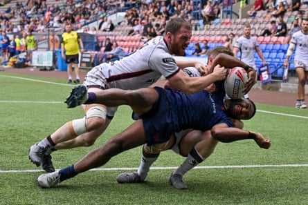 Broncos’ Robert Mathias is held up on the line by the Widnes defence.