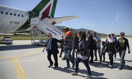 A group of Syrian refugees prepare to board a plane back to Italy with Pope Francis.