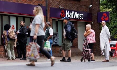 People queue outside a NatWest bank branch in London