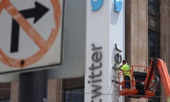 Elon Musk Rebranding Twitter Logo From Bird To "X"<br>SAN FRANCISCO, CALIFORNIA - JULY 24: A worker removes letters from the Twitter sign that is posted on the exterior of Twitter headquarters on July 24, 2023 in San Francisco, California. Workers began removing the letters from the sign outside Twitter headquarters less than 24 hours after CEO Elon Musk officially rebranded Twitter as "X" and has changed its iconic bird logo, the biggest change he has made since taking over the social media platform. San Francisco police halted the sign removal shortly after it began. (Photo by Justin Sullivan/Getty Images)