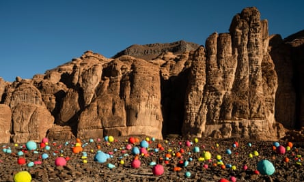 An arrangement of coloured rocks amid scree at the foot of a desert cliff