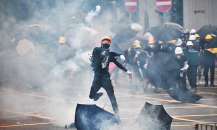 Protester throws teargas canister
