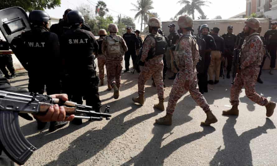 Pakistani troops patrol outside the Chinese consulate in Karachi