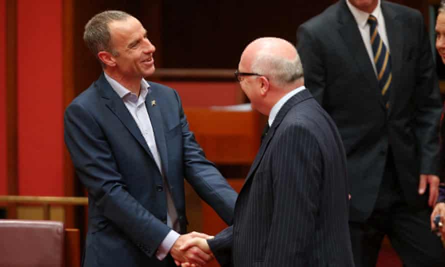 New Tasmanian Greens senator Nick McKim is congratulated by Attorney General George Brandis after making his first speech in the senate chamber of Parliament House Canberra this afternoon, Wednesday 9th September 2015. 