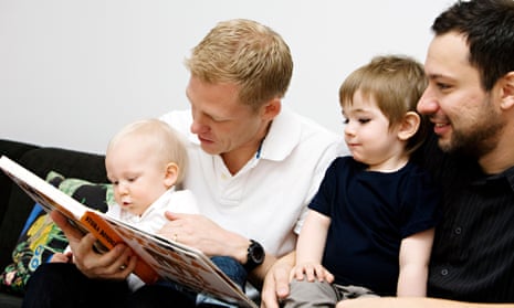 Fathers reading a book to their children
