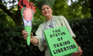 A woman dressed as ‘The Statue of Taking Liberties’ poses outside the US embassy in London.