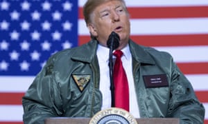 Donald Trump speaks to members of the military during an unannounced trip to Al Asad Air Base in Iraq.