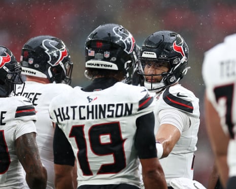 CJ Stroud of the Houston Texans talks with teammates during the warmup before the match against Jacksonville Jaguars at Wembley.