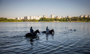 Moscow, Russia: Women cool their horses off in the water at Borisovskye Ponds.