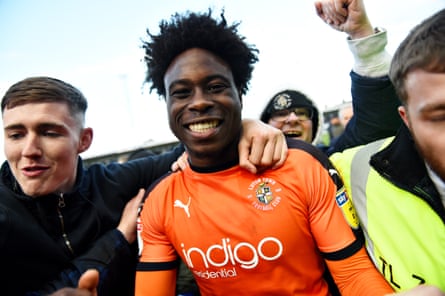 Pelly Ruddock Mpanzu celebrates promotion to the Championship at Kenilworth Road in 2019.