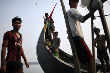 Rohingya refugees crew a fishing boat in the Bay of Bengal