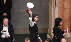 Hungarian MO Bernadett Szel (C) holds a siren-horn next to Agnes Kohalmi (in protest against a ‘slave law’. that loosens labour rules. 5009.jpg?width=300&quality=85&auto=forma