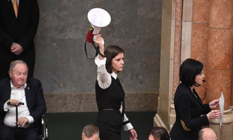 Hungarian MP Bernadett Szél (centre) holds a siren-horn next to Agnes Kohalmi (in protest against a ‘slave law’ that loosens labour rules.