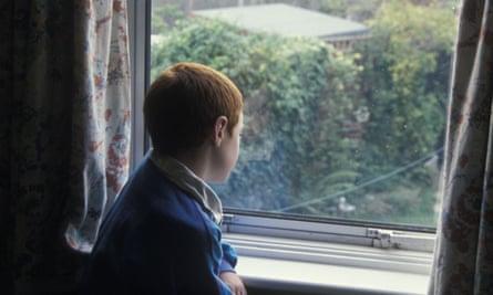 Boy looking out of the window (posed by model)
