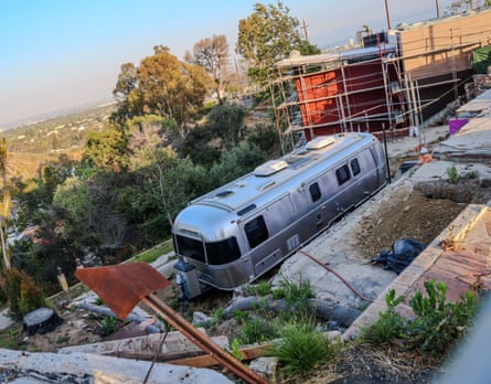 An RV in a vacant lot.