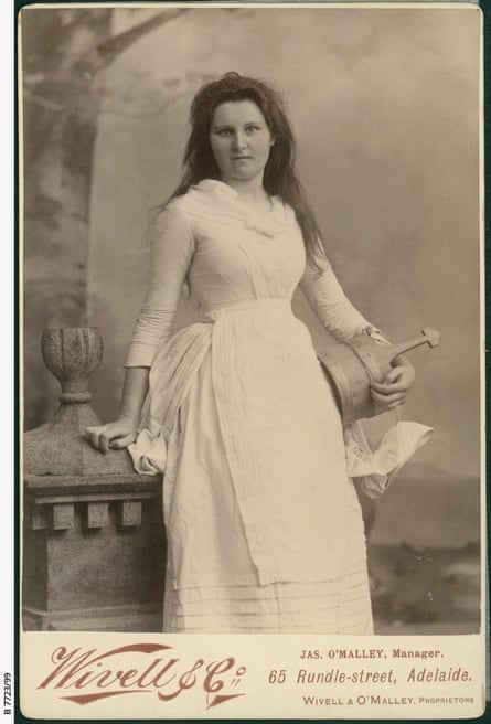 A teenage girl dressed in white holding a milk pail