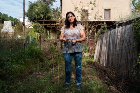 Anita Fornons in Gualba, Spain, with dead sunflowers in what used to be a green garden