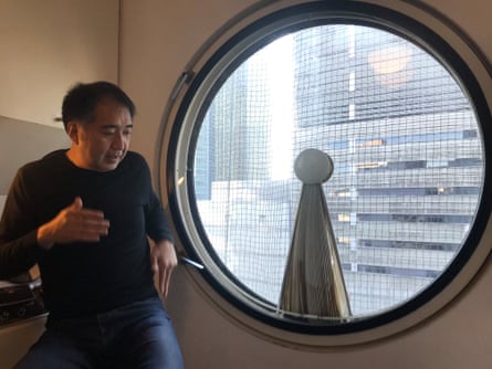 Image of Tatsuyuki Maeda, a Nakagin Capsule Tower resident standing next to window