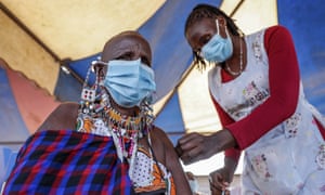 A Maasai woman receives the AstraZeneca coronavirus vaccine at a clinic in Kimana, southern Kenya.