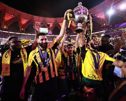 Al-Ittihad’s Karim Benzema and Abdulrahman al-Aboud lift the league trophy among their teammates after winning the Saudi Pro League