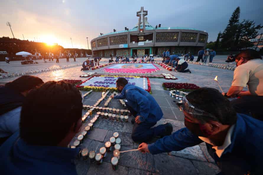 Staff of the Basilica of Guadalupe light candles with messages placed by Catholics prior to the celebration in the central area of the Basilica as part of the Day Of Our Lady Of Guadalupe Celebrations at Basilica de Guadalupe on 11 December, 2020 in Mexico City, Mexico.