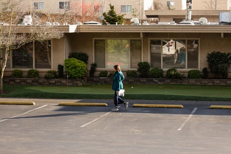 A woman leaves Life Care Center of Kirkland on February 29, 2020 in Kirkland, Washington. Dozens of staff and residents at Life Care Center of Kirkland are reportedly exhibiting coronavirus-like symptoms, with two confirmed cases of (COVID-19) associated with the nursing facility reported so far. 