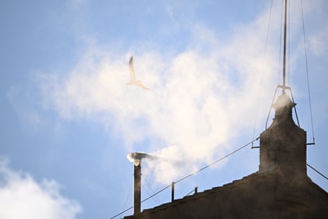 White smoke rises from the chimney on the Sistine Chapel, indicating that a new pope has been elected at the Vatican.