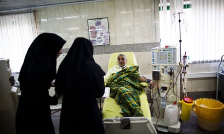 Nurses check on a patient receiving treatment at clinic in Tehran.