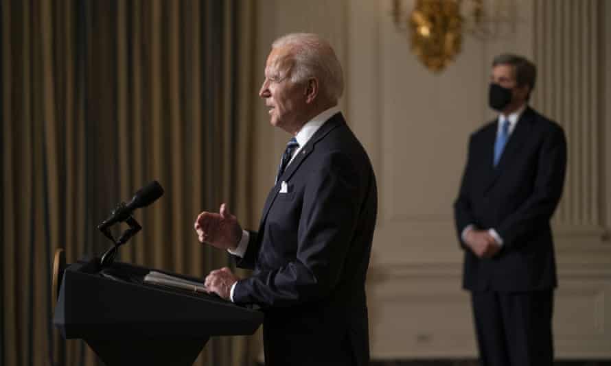 John Kerry, right, the president’s climate envoy, listens as Joe Biden delivers remarks on the climate crisis shortly after taking office.