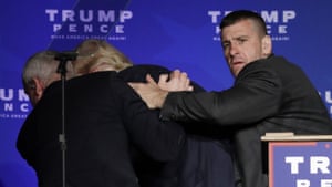 Members of the Secret Service rush Republican presidential candidate Donald Trump off the stage at a campaign rally in Reno, Nevada.