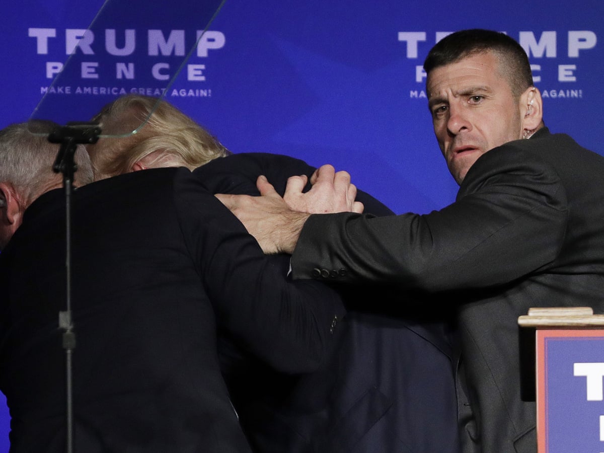 Donald Trump is rushed off stage by Secret Service agents at ...