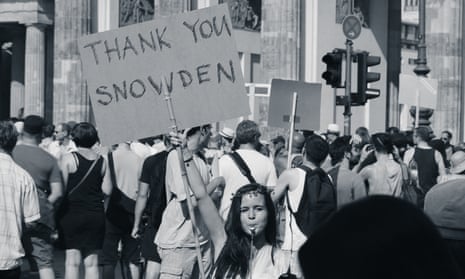 A woman holds a placard that says THANK YOU SNOWDEN.
