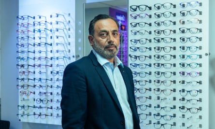 Optician Mohammed Zubair pictured in front of numerous glasses in his store on Alum Rock Road in the Ladywood constituency of Birmingham