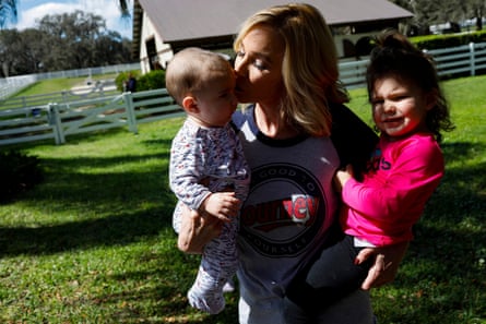Pastor Paula White-Cain holds her granddaughter, Asher, 2, (right) while kissing her grandson Nicholas, 6 months old, at her home in Apopka, Florida on Thursday, February 28, 2019. White-Cain is a senior pastor at New Destiny Christian Center. Eve Edelheit for The Guardian